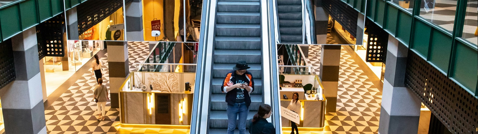 people on escalators in a mall