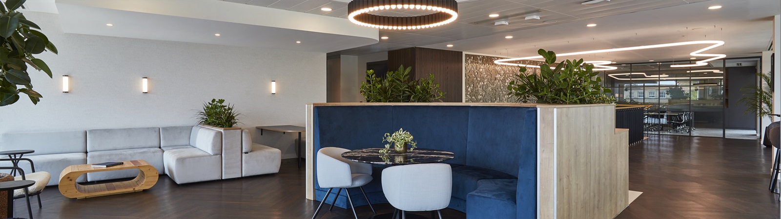 A part of the Mishcon de Reya Cambridge office with a blue booth and chairs