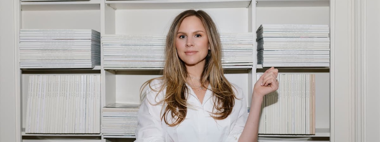 a person standing in front of a shelf of books