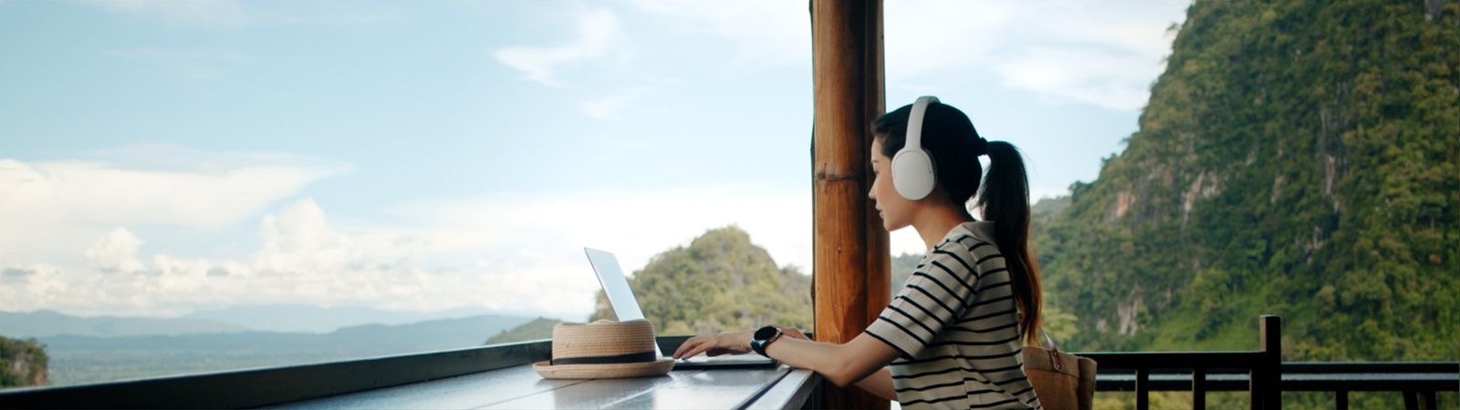 a person sitting at a table with a laptop