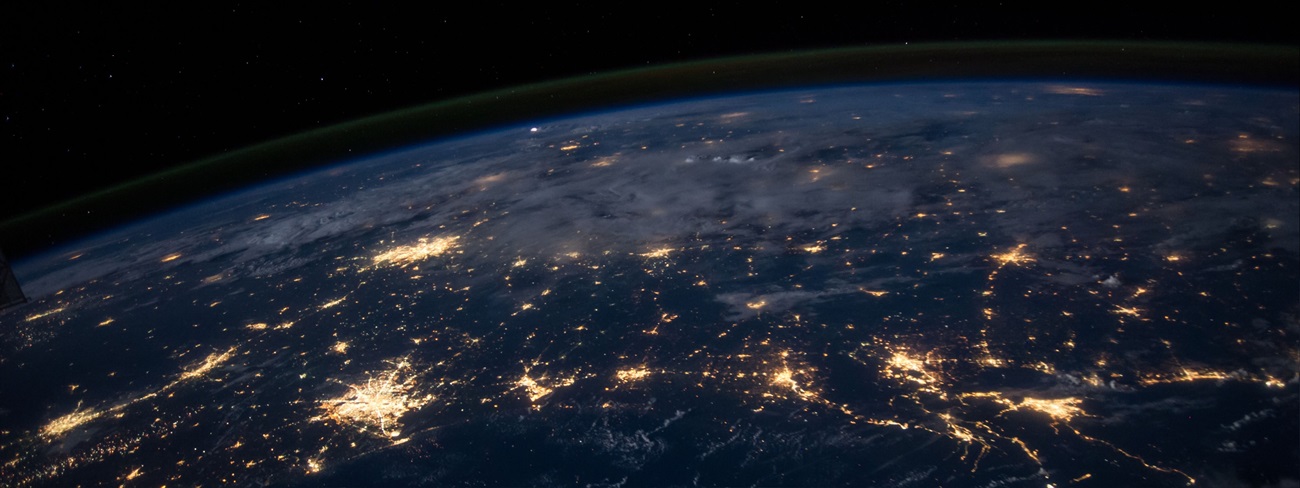 The earth from low level orbit at night featuring many illuminated cities