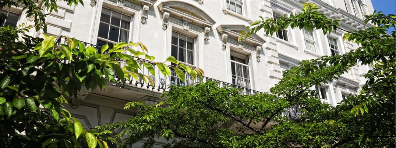 a white building with trees in the background