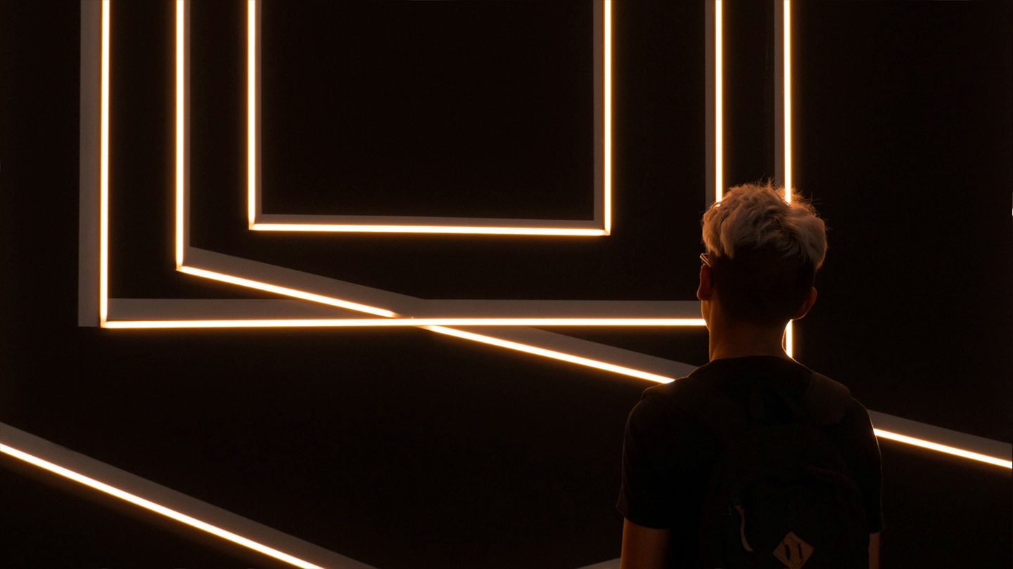 a person looking at a light installation