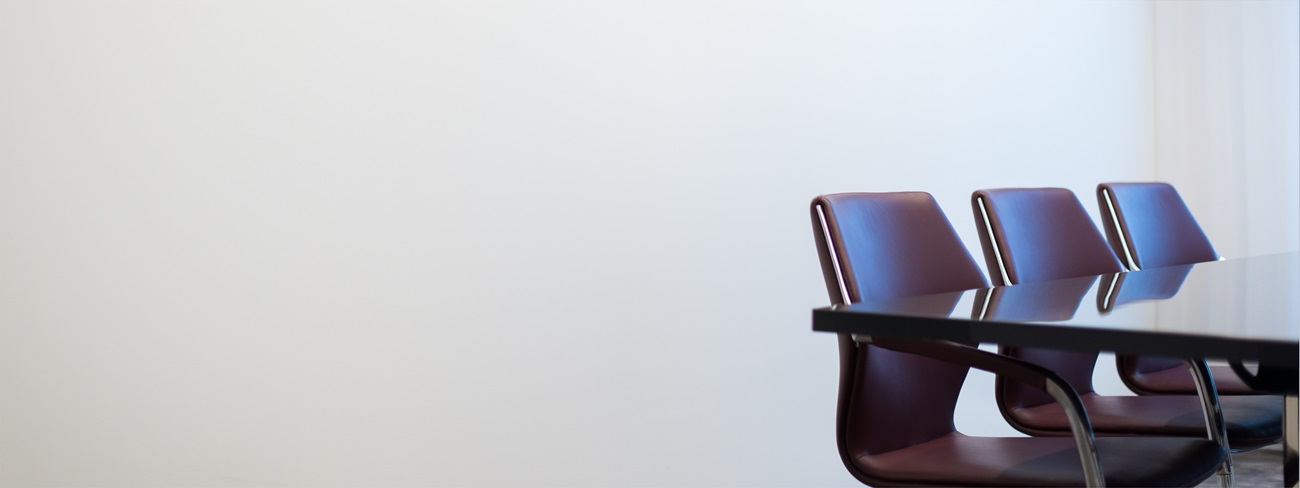 Brown chairs round a meeting table